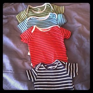 4 Stripped onesies in various colors